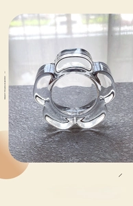 Close-up of petal-shaped glass candle holder with thick crystal texture and clear finish