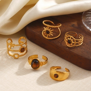 Five-piece set of vintage 18k gold plated stainless steel rings with tiger eye stone accents