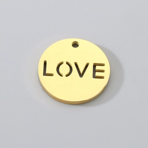 Close-up of golden stainless steel hollow circular LOVE pendant for jewelry making