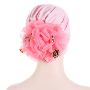 Detail of pink pleated turban hat with a large 3D mesh flower and sparkling gems