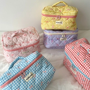 Quilted checkerboard cosmetic bags with bow patterns in various colors for travel