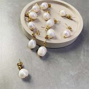 Flat lay of baroque freshwater pearl earrings with gold-plated stainless steel accents