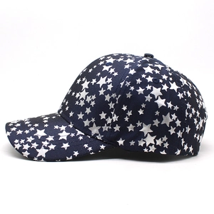 Detail of navy blue baseball cap featuring all-over white star print and cotton twill fabric