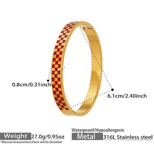 Macro shot of stainless steel bangle featuring red and gold checkered pattern with measurements