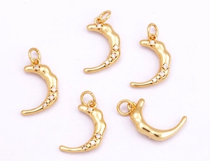 Detailed view of five golden crescent moon pendants with inlaid white zircons for jewelry making