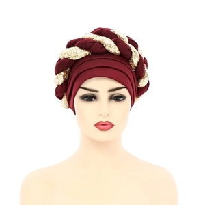 Front view of burgundy pleated turban hat with sparkling gold sequin braid details