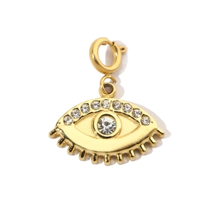 Macro view of gold-plated evil eye charm pendant with sparkling cubic zirconia stones