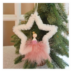 Detailed close-up of a plush angel ornament with feather skirt on a Christmas tree branch
