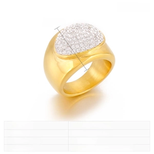 Close-up of golden stainless steel wide ring with sparkling rhinestones and clay inlay