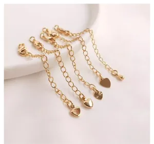 Detail of 14K gold plated extender chains with heart and teardrop shaped charms