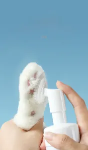 Detail of dog paw cleaning foam with a built-in massage brush for waterless pet care
