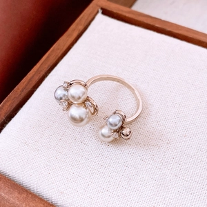 Detail of open gold ring with white and grey pearls plus sparkling zircon accents