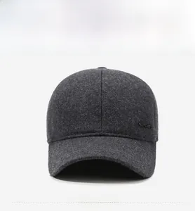 Detail view of the thick wool fabric texture and embroidered sport logo on the winter cap