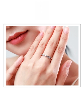 Detail of s925 silver crossover heart ring with sparkling diamonds worn on a finger