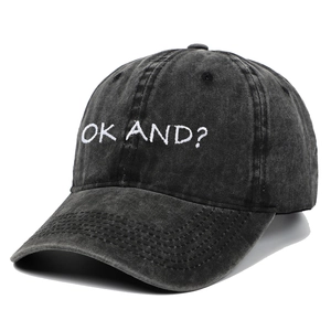 Detail of vintage washed black cotton baseball cap featuring OK AND? white embroidery
