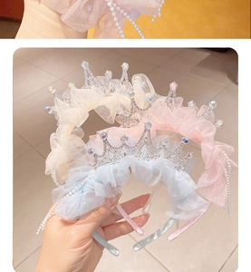 Close-up of girls crown headbands in pink, yellow and blue with rhinestones and lace