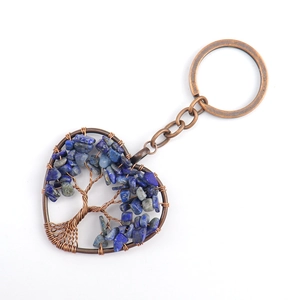 Detail of handmade bronze heart tree of life keychain with blue lapis stone chips