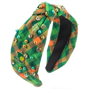 Close-up of St. Patrick's Day green plaid knotted headband with rhinestones and charms