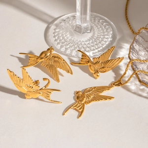 Golden swallow jewelry set with engraved feather texture on necklace and earrings