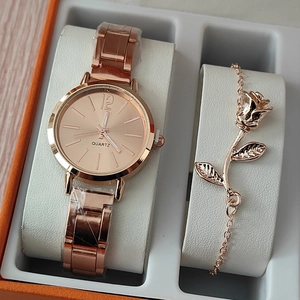 Close-up of rose gold watch and rose flower bracelet set in a professional gift box