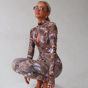 Close-up of brown fluid print jumpsuit with metallic texture and chest cutout detail