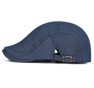 Side view of dark blue denim duckbill cap with adjustable bronze metal side buckle