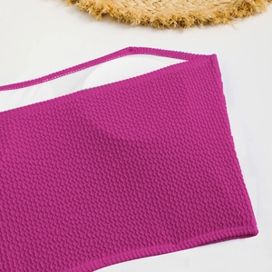 Detailed view of mauve seersucker bikini top with textured fabric and white inner pads