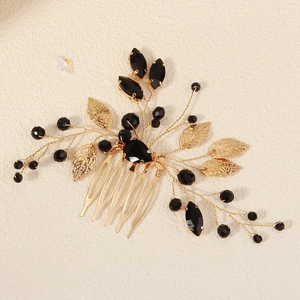 Detail of vintage bridal hair comb with black marquise gems and gold leaf metalwork