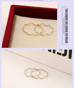 Detailed macro view of gold and silver wavy texture titanium steel rings for women