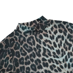Detailed close-up of the leopard print turtleneck collar on this stylish long sleeve dress