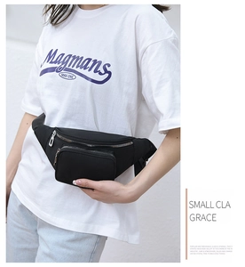 Detailed view of black water-resistant fanny pack with silver zippers worn by a model