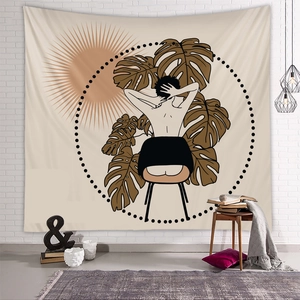 Detail of bohemian tapestry featuring minimalist line art and Monstera leaves on a wall