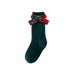 Dark green Christmas knee high socks for kids with a red plaid bow decoration