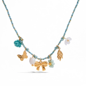 Close-up of blue cord necklace with gold butterfly charms and floral bead accents