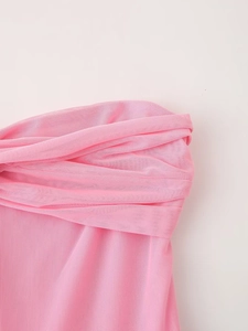 Detailed close-up of pink layered mesh fabric and pleated texture on a strapless dress