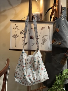 Minimalist canvas tote bag featuring all-over cartoon dog prints on a natural white fabric