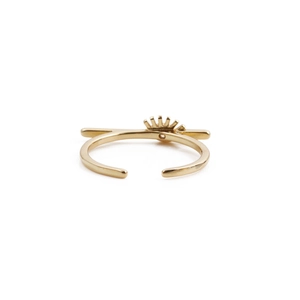 Golden evil eye eyelash ring with cubic zirconia and sunburst design on white background