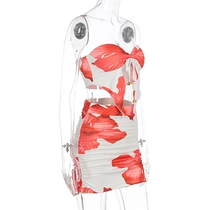Detail view of red floral tube top and ruched skirt set showing side drawstring and pleats