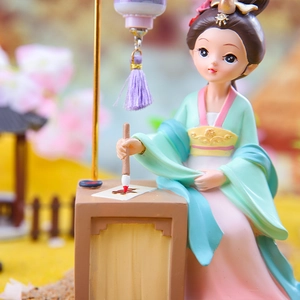 Detailed view of ancient Chinese girl figurine painting with brush and lantern