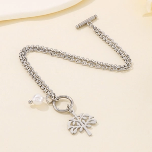 Detail of OT clasp closure on double-layer stainless steel bracelet with tree charm