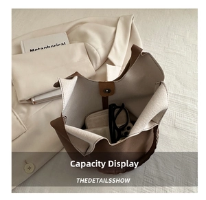 Interior view of brown leather bucket bag showing capacity with glasses and wallet