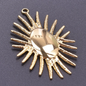 Close-up of 18k gold plated stainless steel sunburst pendant with polished oval center