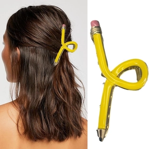 Macro view of creative pencil-shaped hair claw clip with pink eraser detail and glossy finish