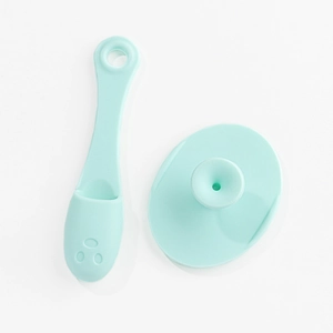 Detail view of mint green silicone facial cleanser brush set with applicator and suction pad