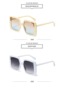Detail view of square oversized sunglasses in beige and white frames with gradient lenses