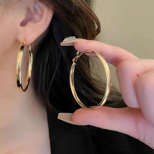 Minimalist large golden hoop earrings in geometric style for stylish everyday wear