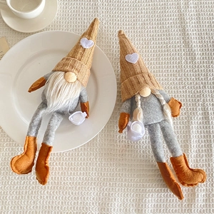 Pair of handmade knit Christmas gnomes with heart hats and dangling legs for home decor