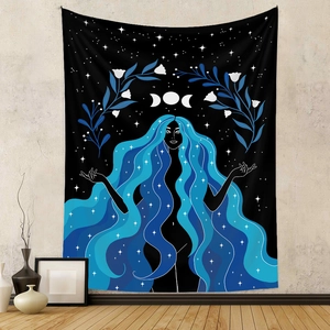 Detail of bohemian tapestry featuring a moon goddess portrait over a grey wall