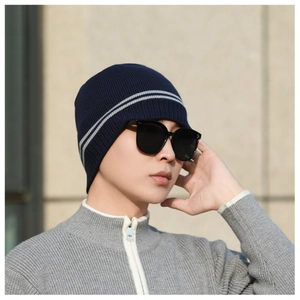 Detailed texture of navy knit beanie with gray stripes and warm thermal ribbed finish