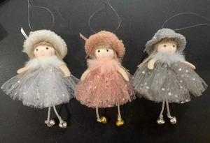 Detailed view of three girl dolls with sequined mesh skirts and bells for tree decor